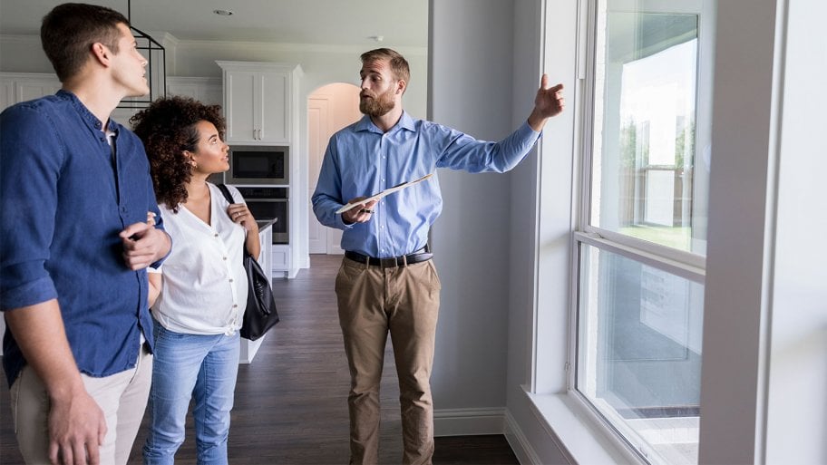 couple discussing windows with inspector