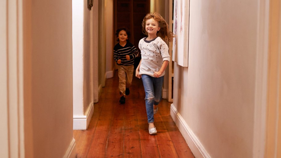 Kids running down hallway with wood floors