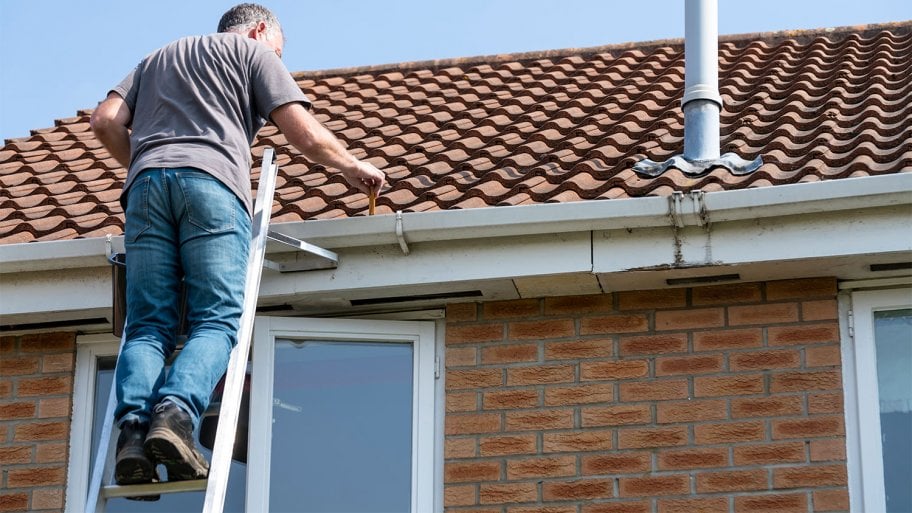 man cleaning roof