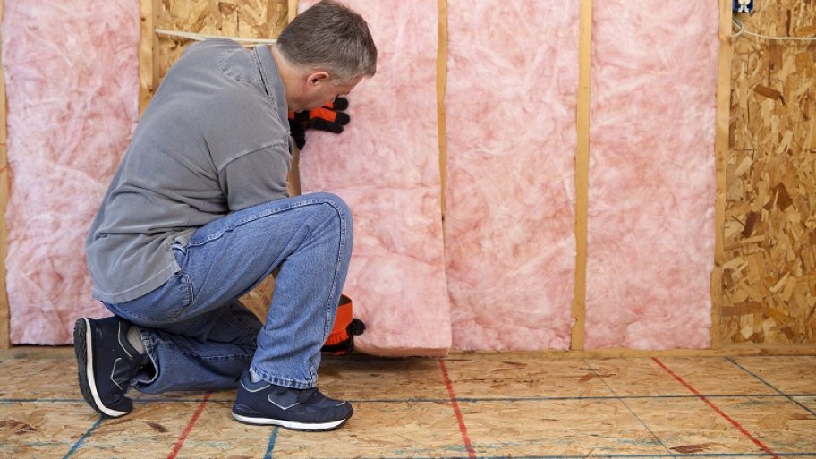 Man installing insulation