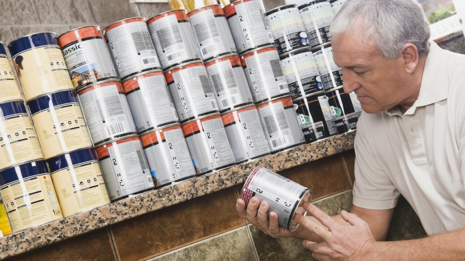 Man picking paint at hardware store