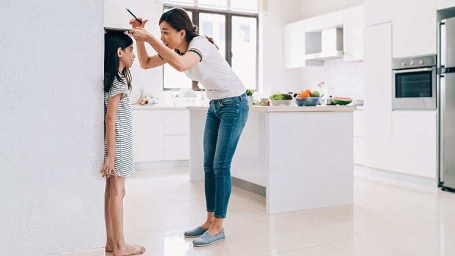 Measuring height of child on a big wall, open concept kitchen