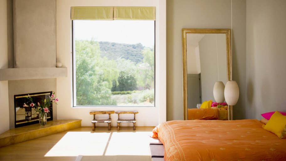 A modern bright bedroom with a fireplace