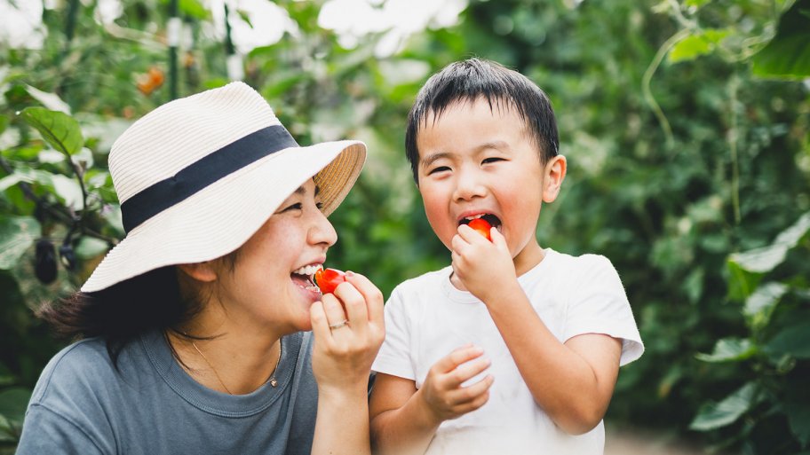 mother and child eating in the garden