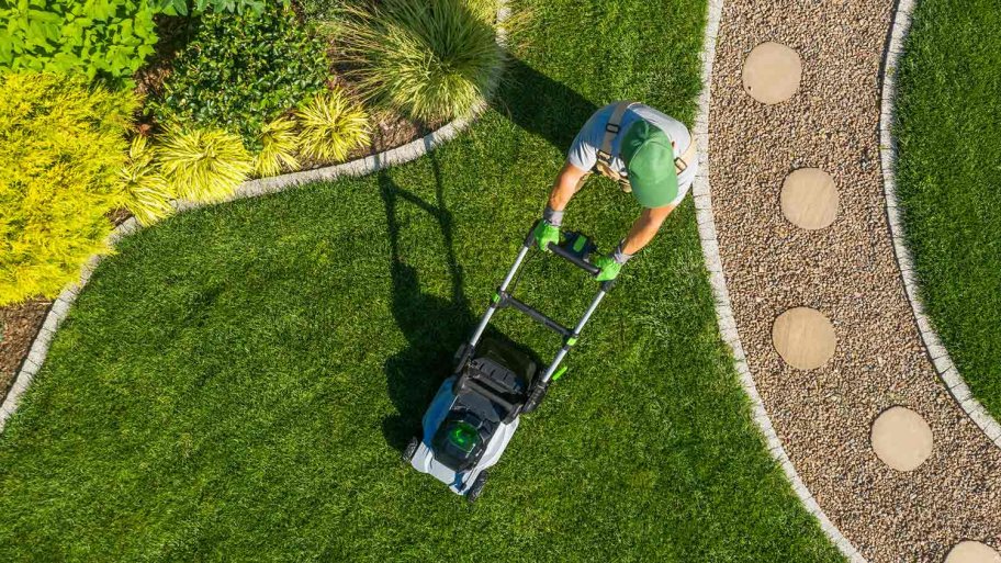 Aerial view of man mowing yard