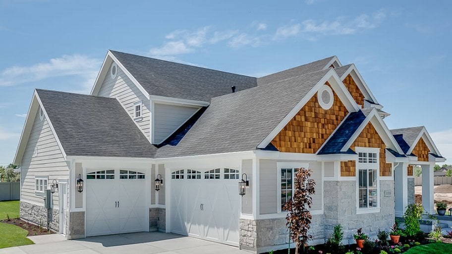 Garage view of home with shingle roof Garage view of home with shingle roof