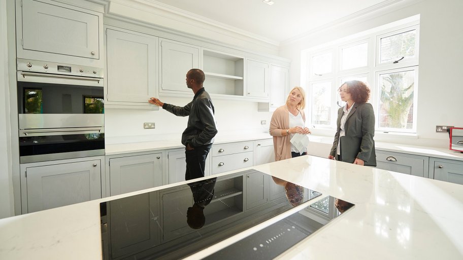 Realtor shows home owners around house