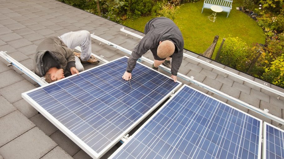 Men repairing a solar panel