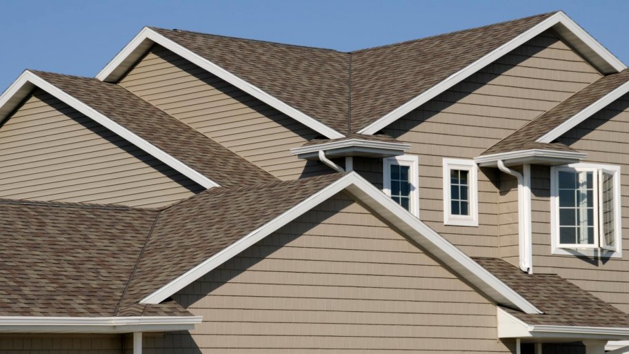 A closeup of a rooftop against a bright blue sky