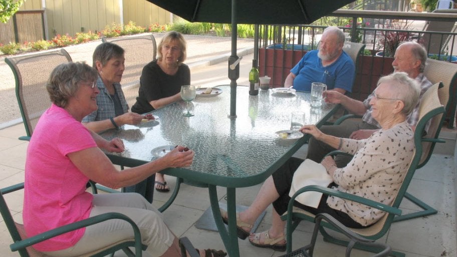 seniors seated at patio table