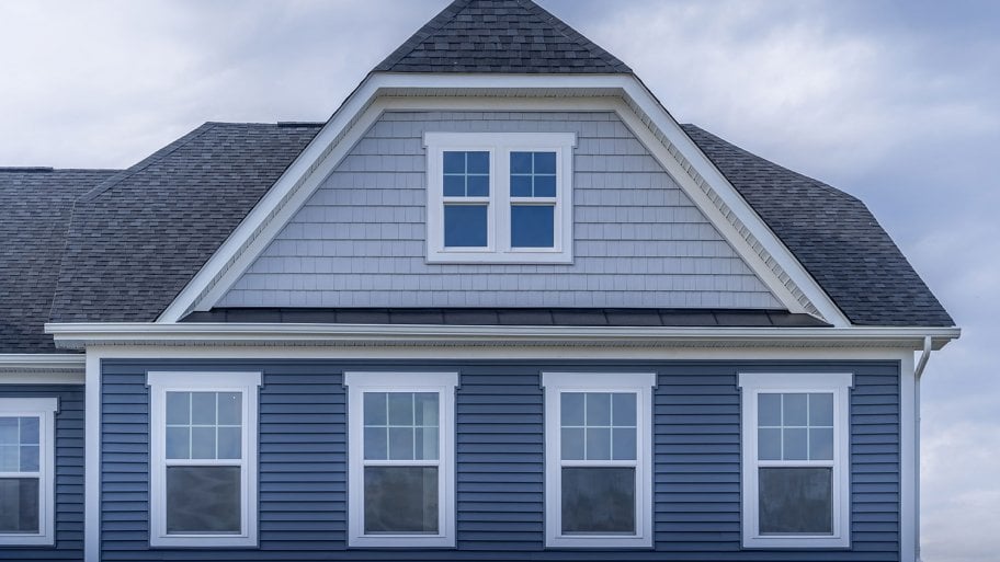 Shingles on a gabled roof of a brick house