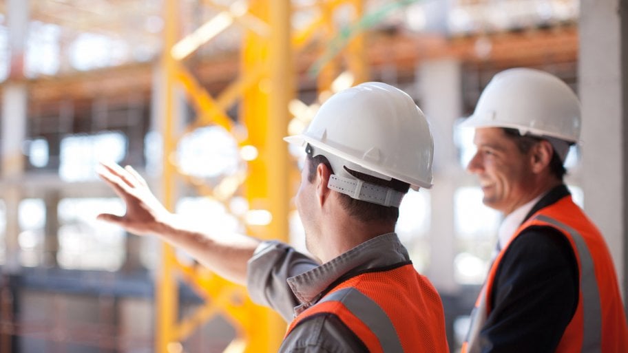 A subcontractor showing the construction site to a contractor
