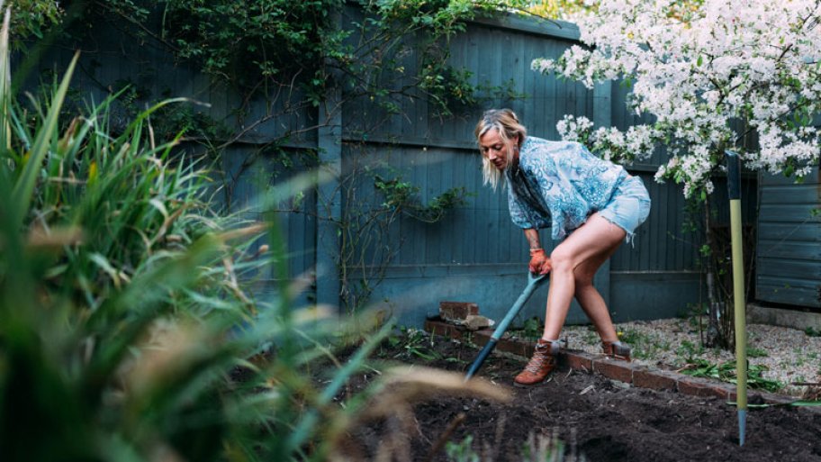 woman gardening vegetable garden mulch