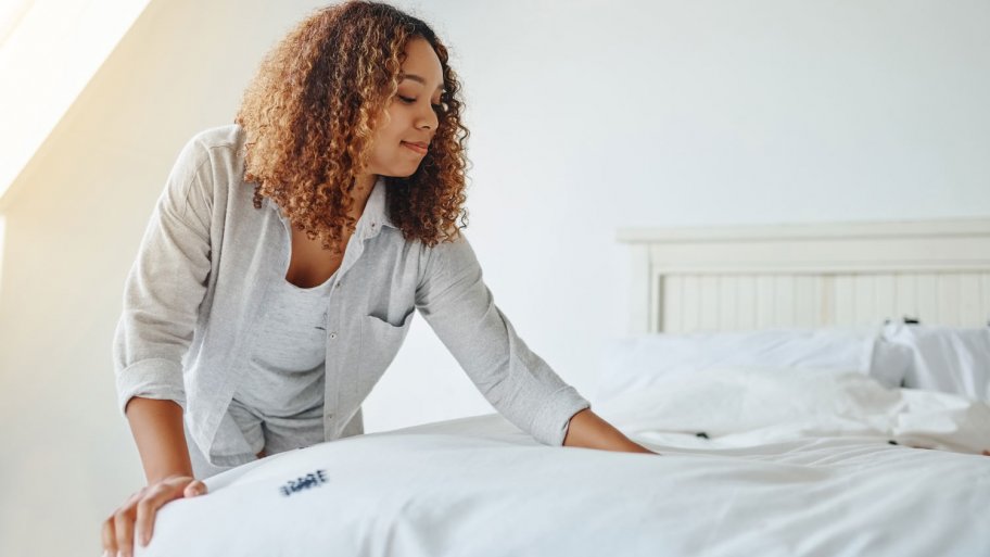 woman making white clean bed