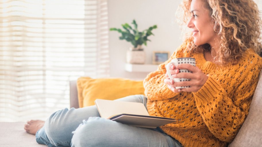 Woman on sofa in yellow sweater