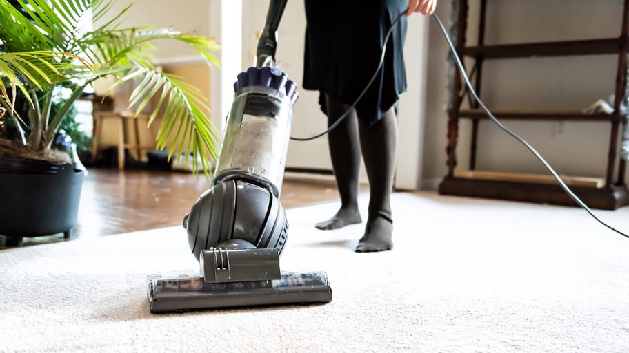 woman vacuuming a carpet
