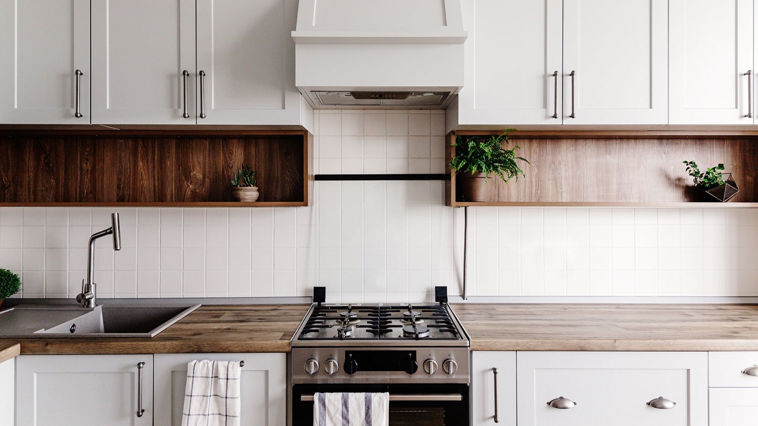 A stylish kitchen interior with grey cabinets