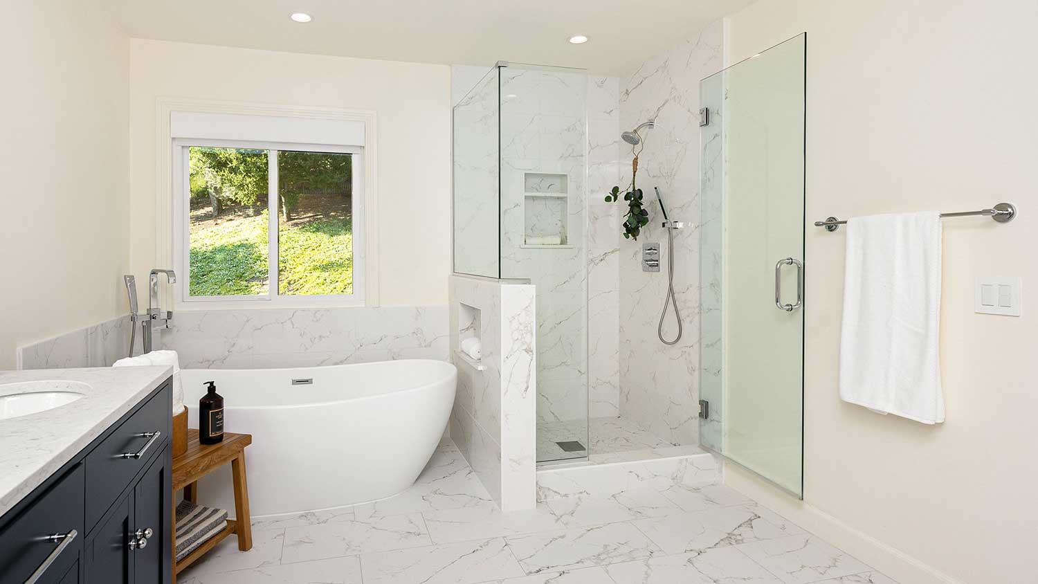 Master bathroom with bathtub and a shower stall
