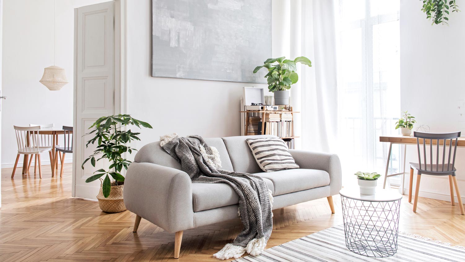 A stylish scandinavian living room with design furniture and plants