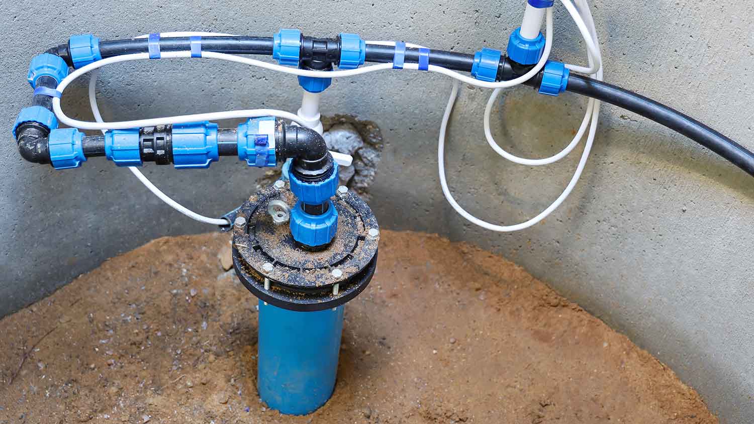 Submersible well pump system installed in a concrete tank