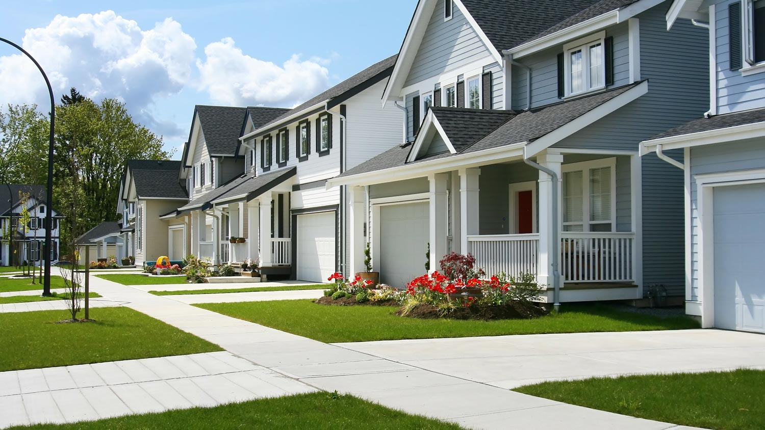 A suburban neighborhood with a row of white houses