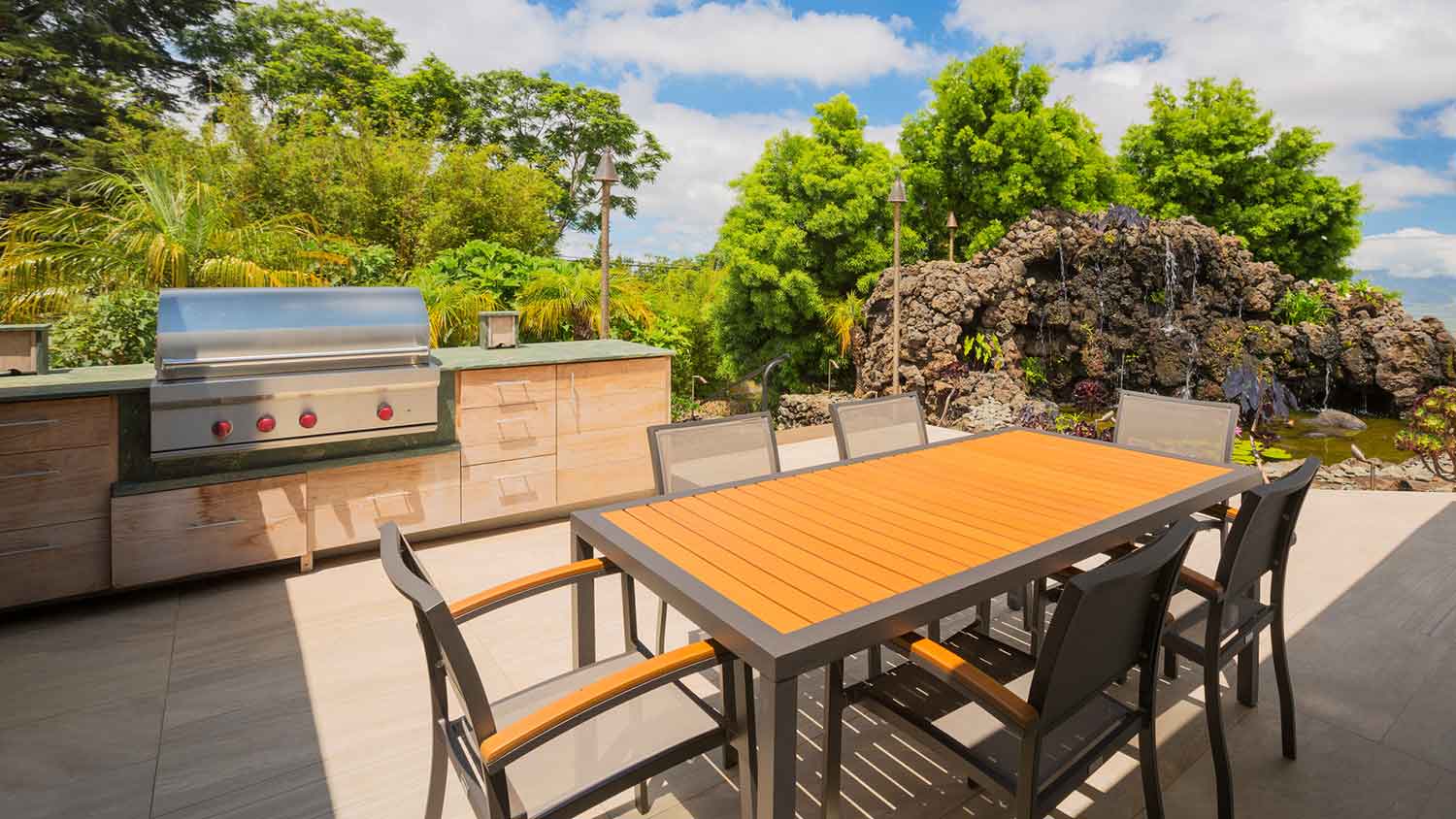 Summer kitchen with gas grill and dining table