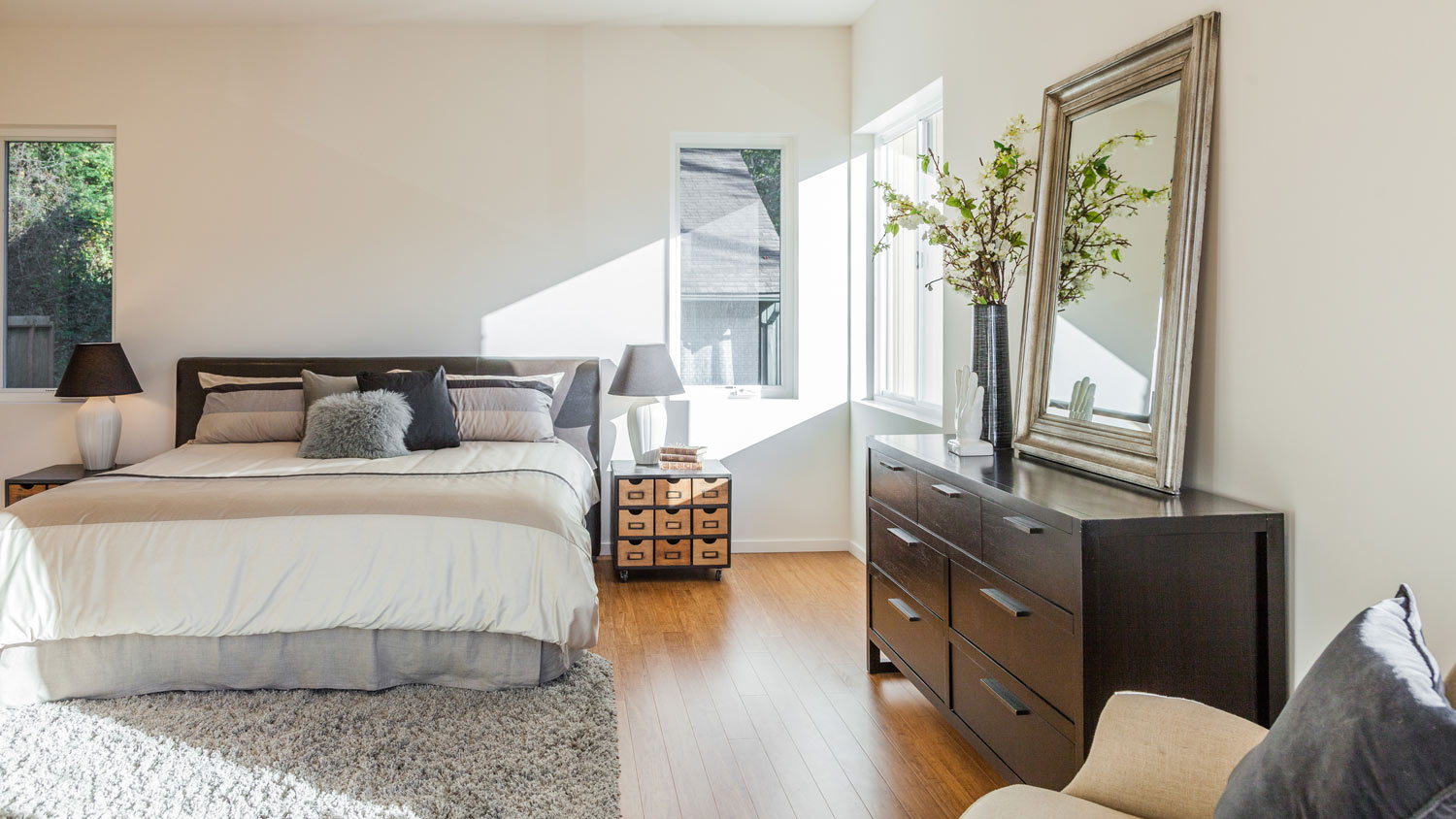 A sunlit contemporary bedroom with upcycled nightstand