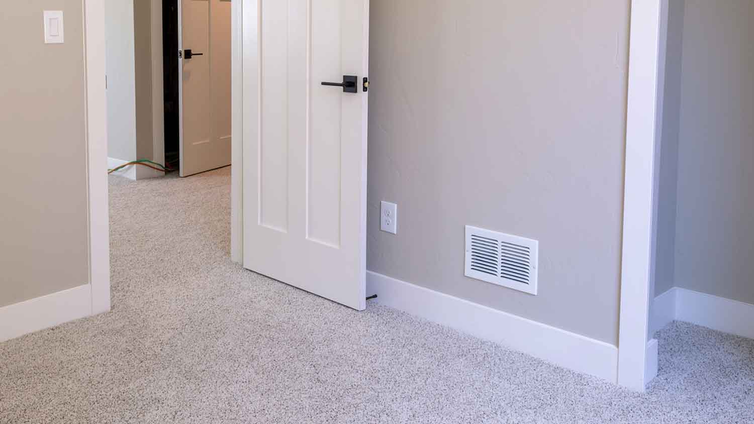 Supply air vent near the floorboard in the room
