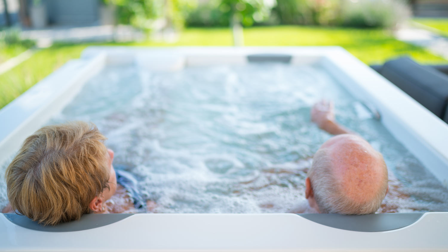 couple in swim-spa hot tub