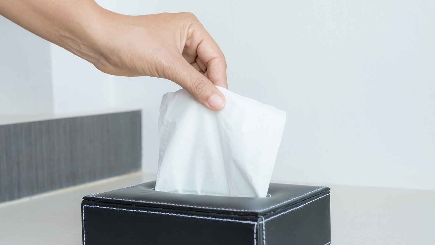 Taking tissue paper from tissue box