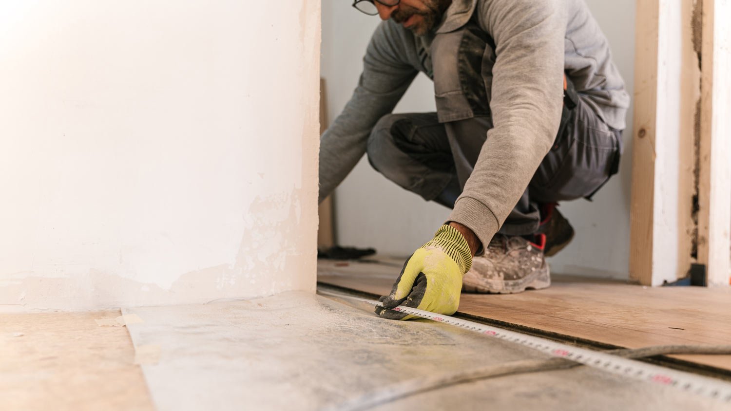 Carpenter measuring floor