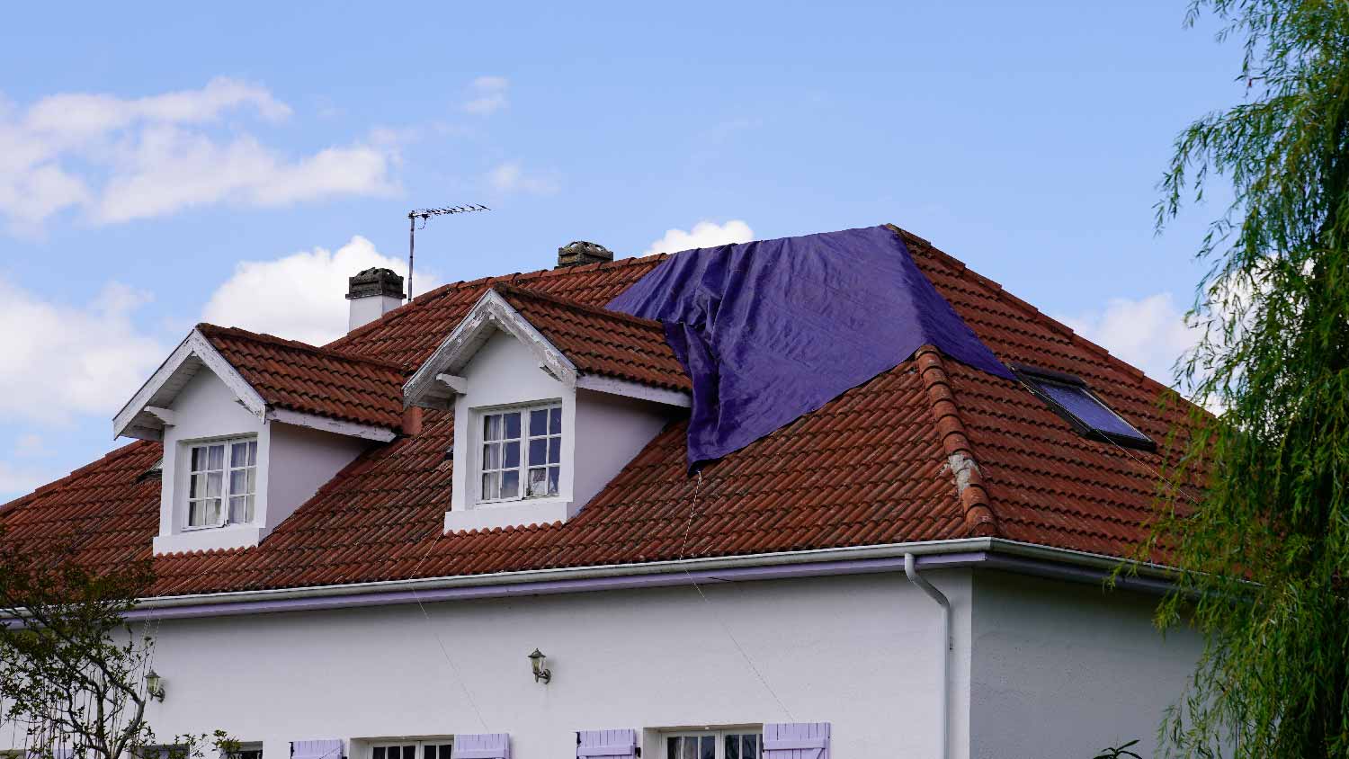 Tarp waiting to be installed on a roof 