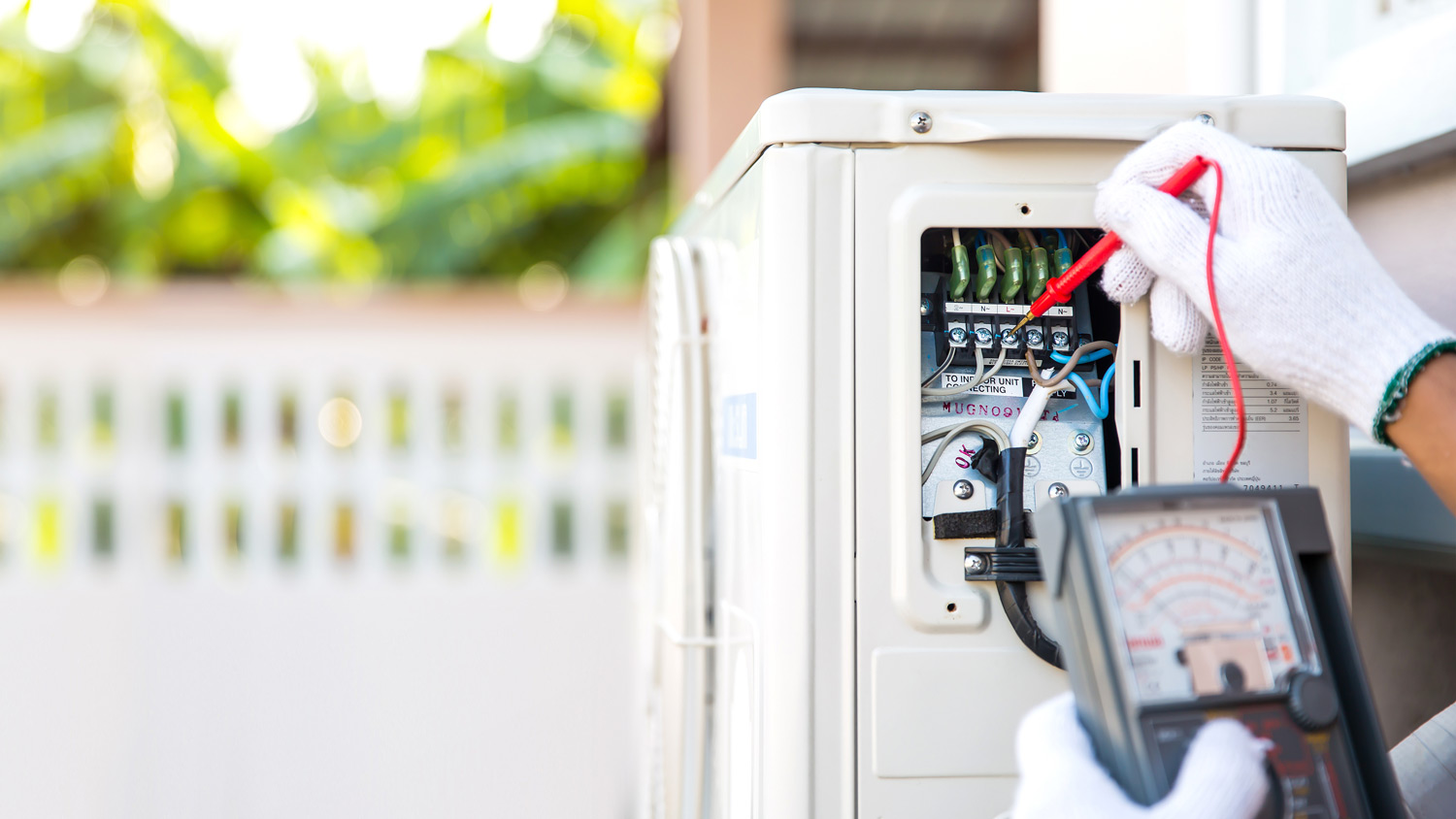 A techinician checking a heat pump