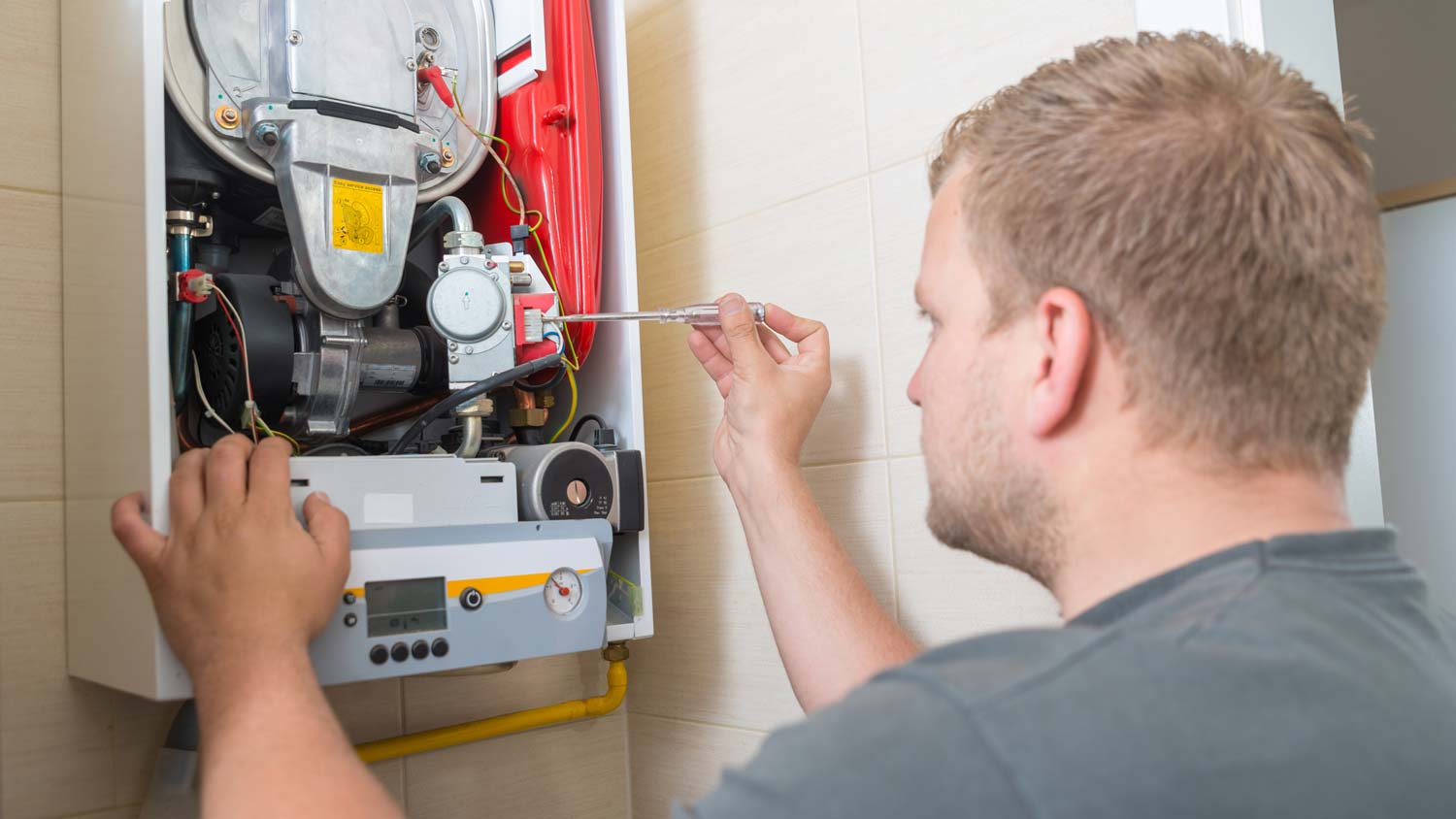 A technician inspecting a furnace