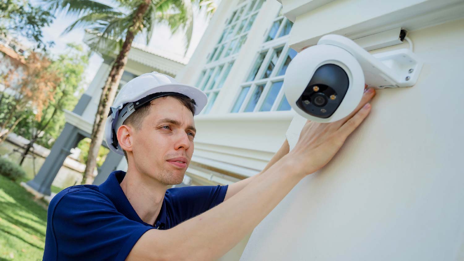 A technician installing a CCTV camera