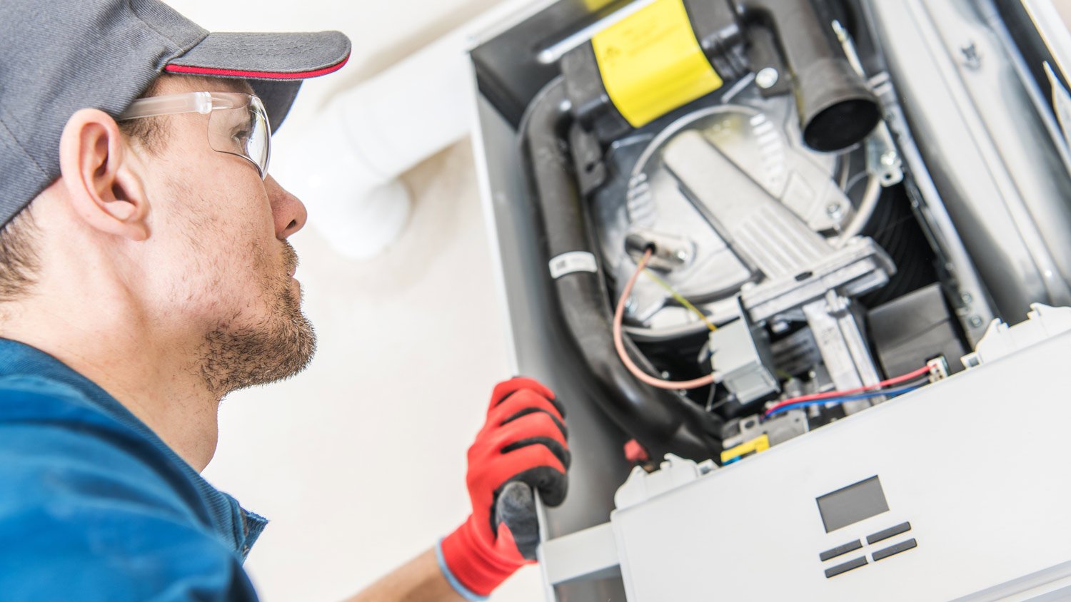 A technician repairing a furnace