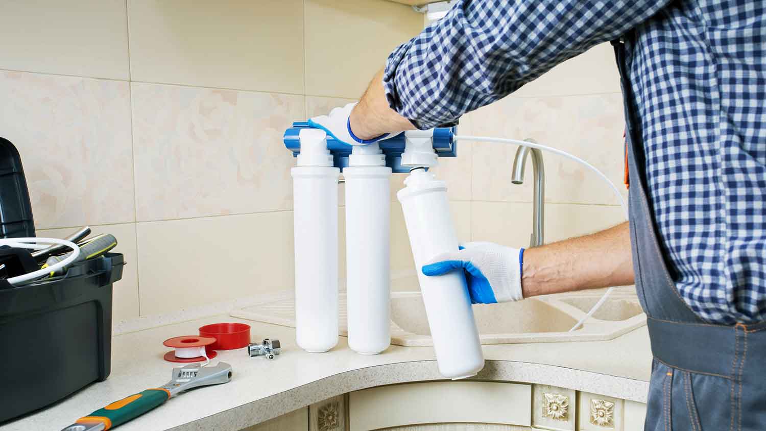 Technician replacing reverse osmosis water filter