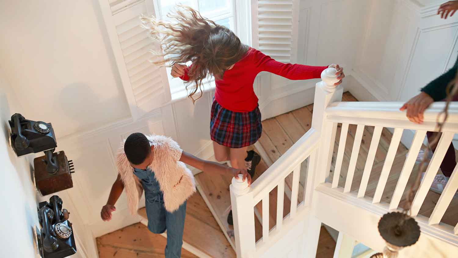 A group of teenage girls running down the stairs