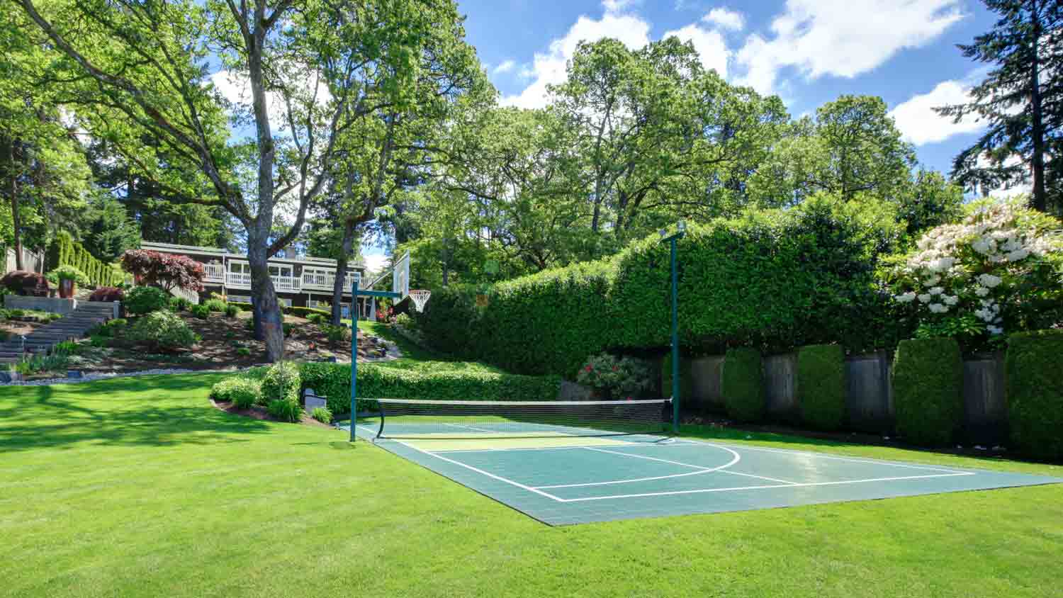 tennis court on hill of large property