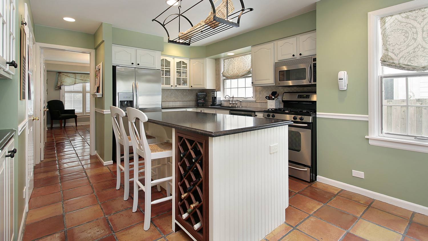 A kitchen with terracotta tiles for flooring