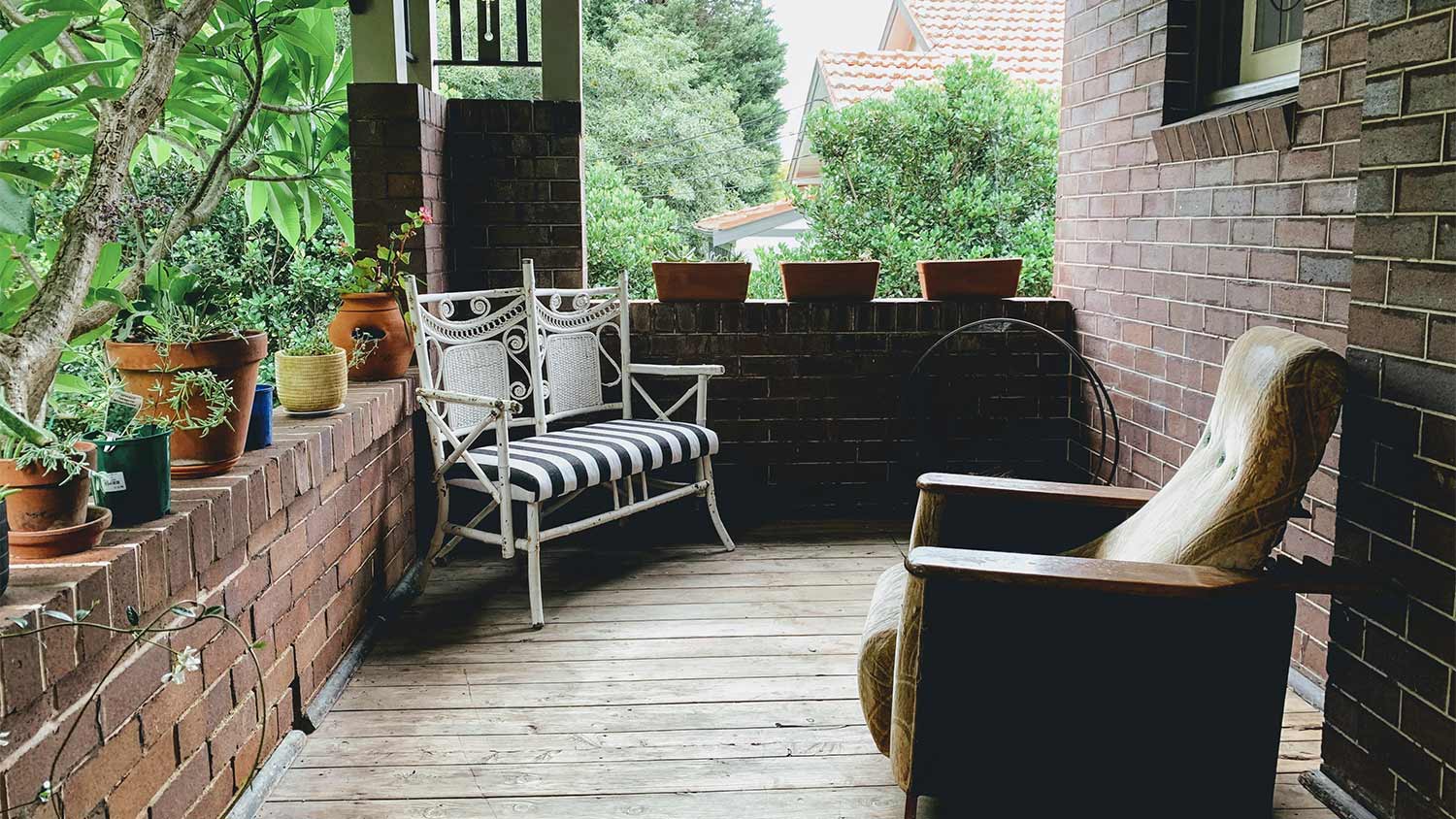 A porch with terracotta pots and seating