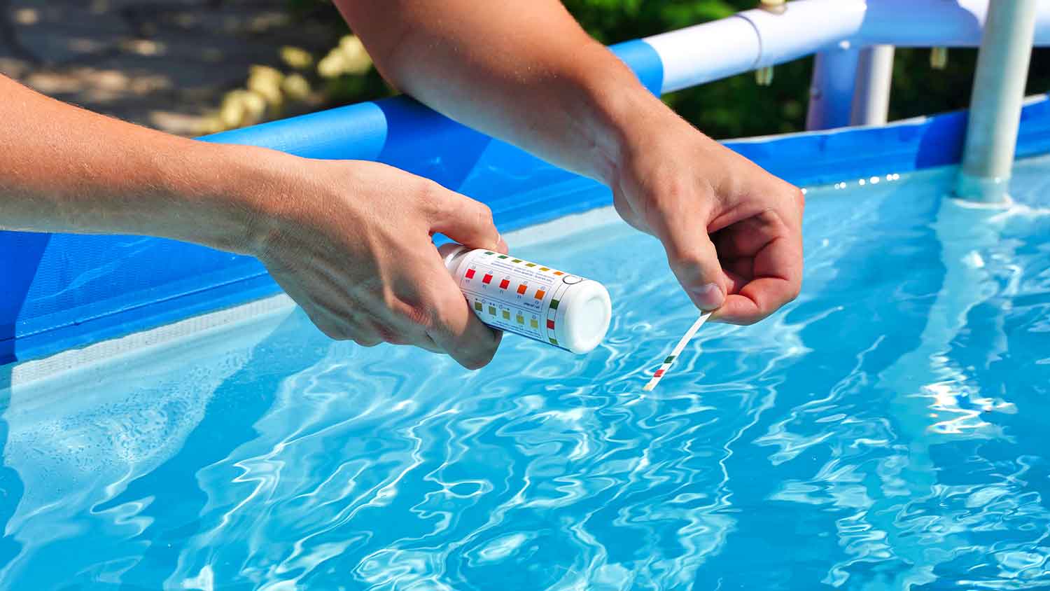 Using a test kit to check swimming pool water quality
