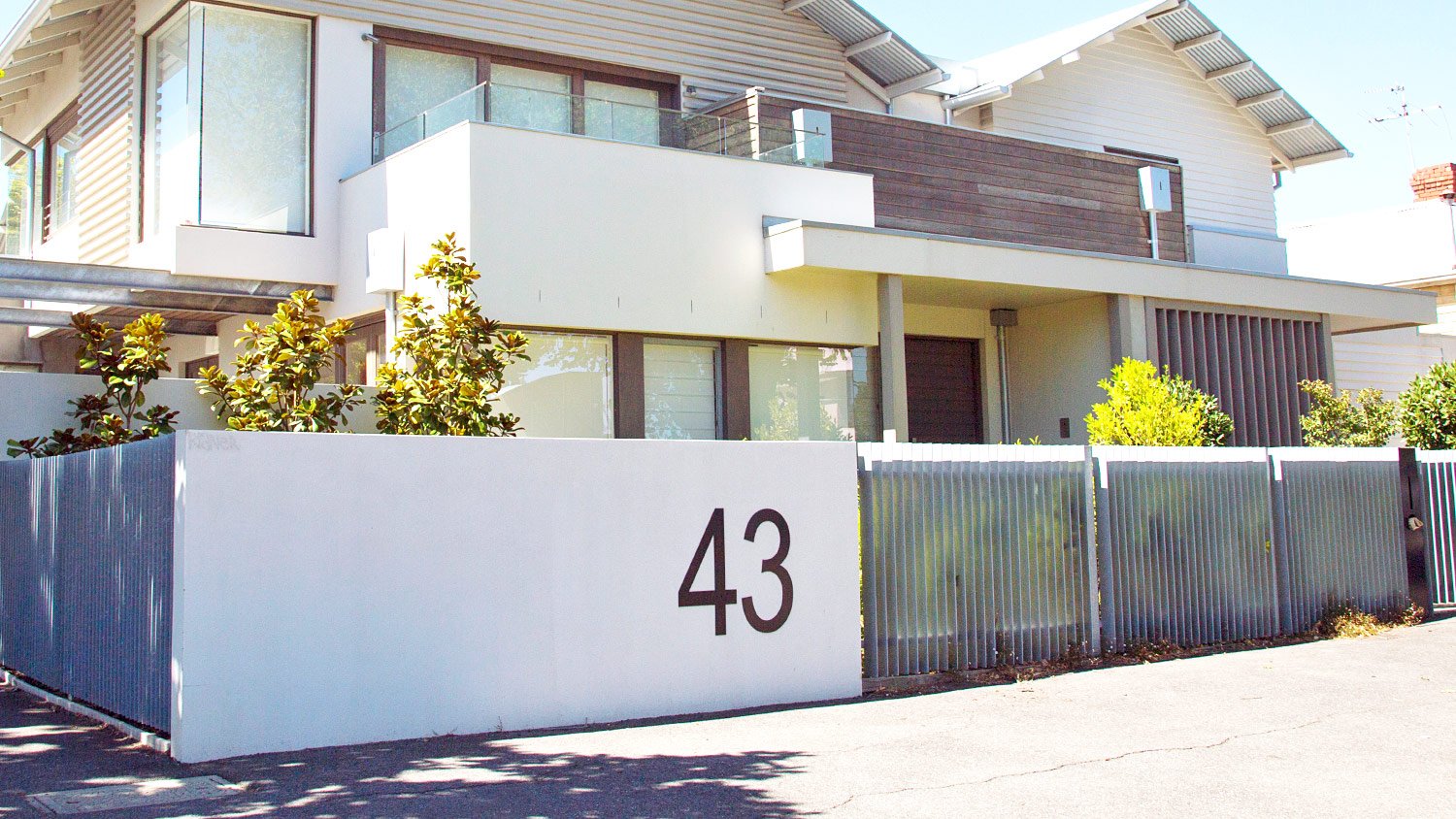 front of home with fence with number 43 on side