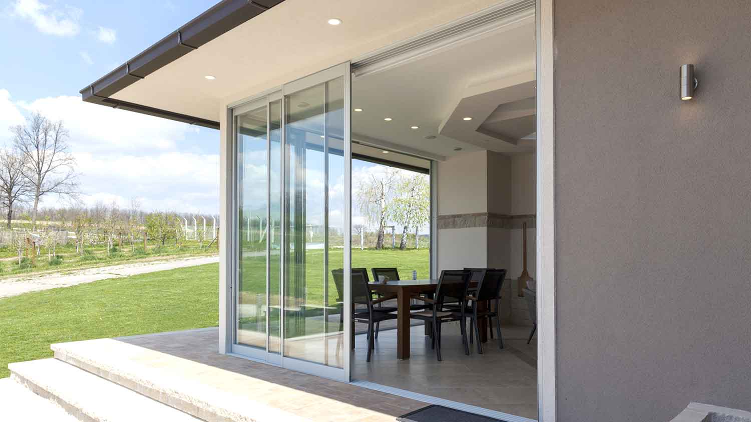 Sliding patio door with triple track rail 