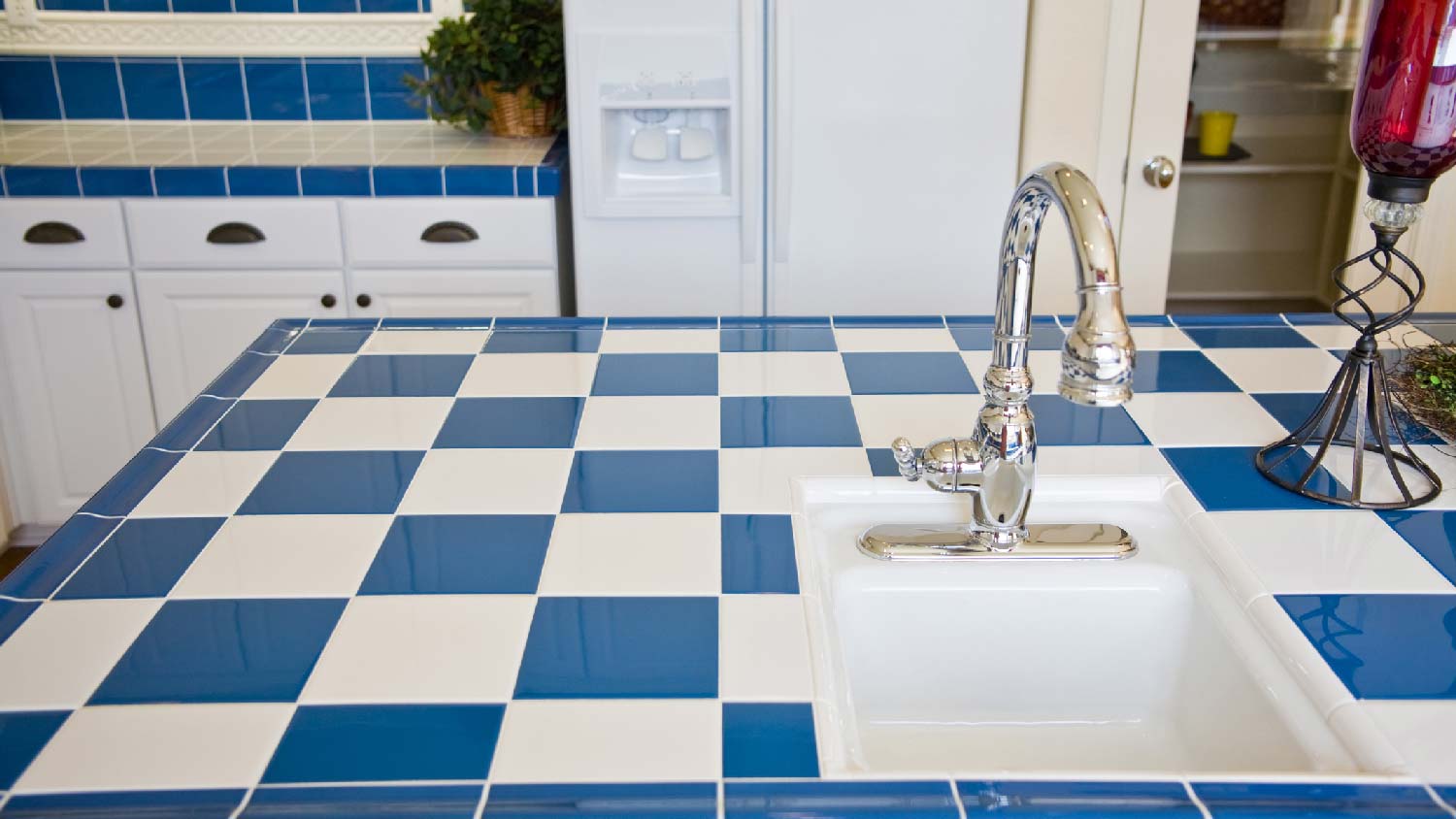 A blue checkered tiled countertop in a kitchen