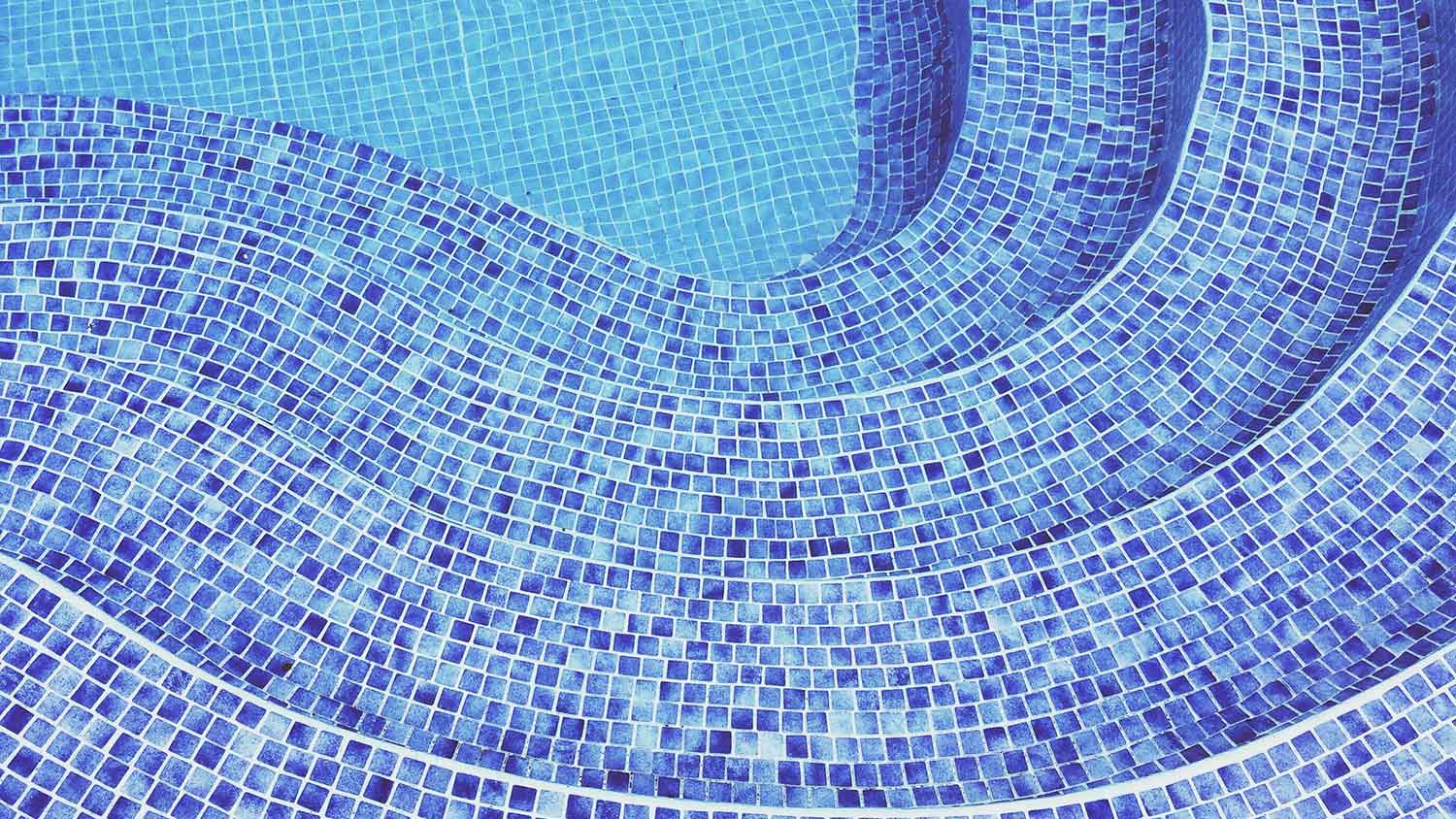 Swimming pool steps covered with blue tiles