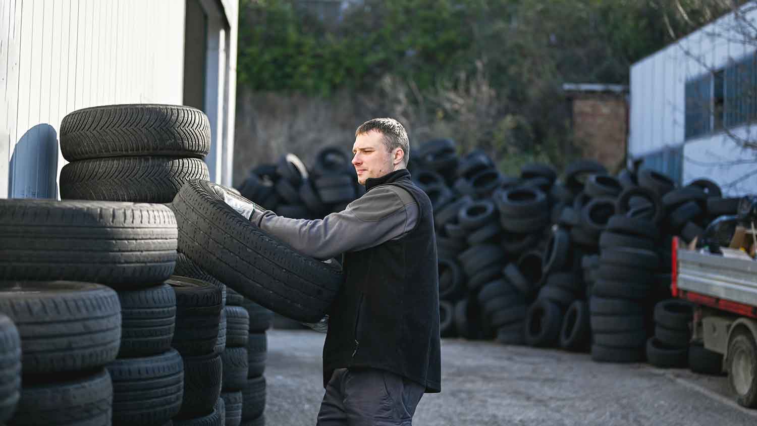 Person bringing a scrap tire to a recycling facility