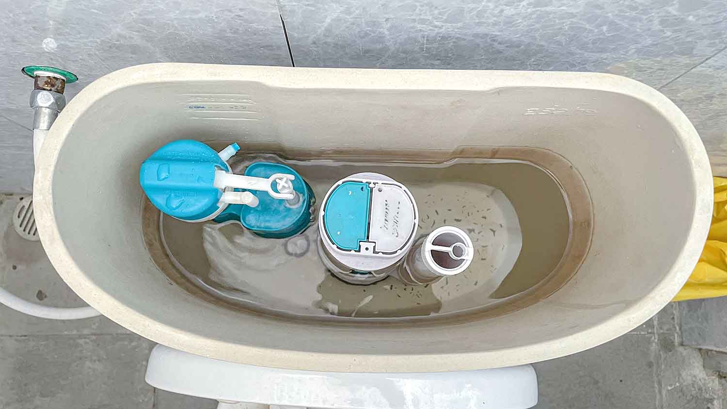 Toilet float cup installed in a toilet tank