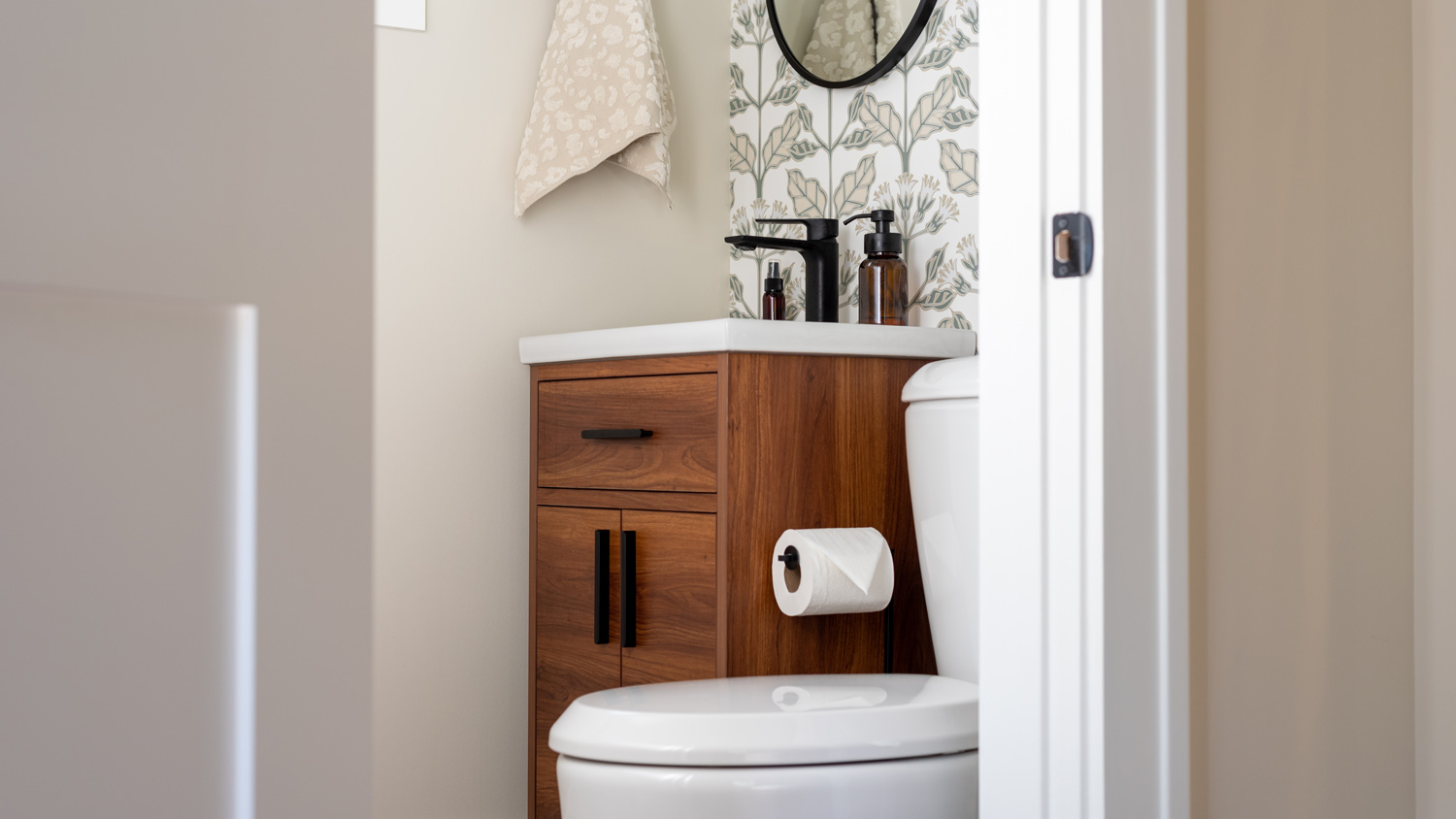 Stylish small bathroom with wallpaper accent wall  