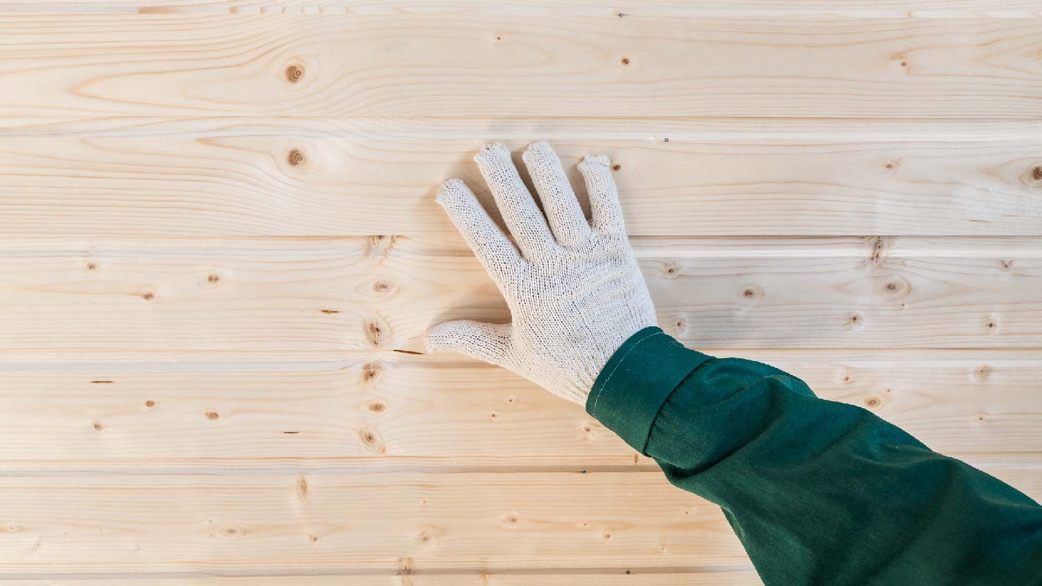 A person finishing a tongue and groove ceiling